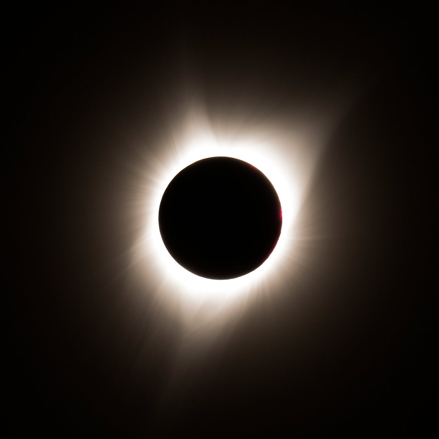 A total solar eclipse captured in 2017 in eastern Oregon, showing the darkened moon perfectly centered with the sun’s glowing corona radiating outward.