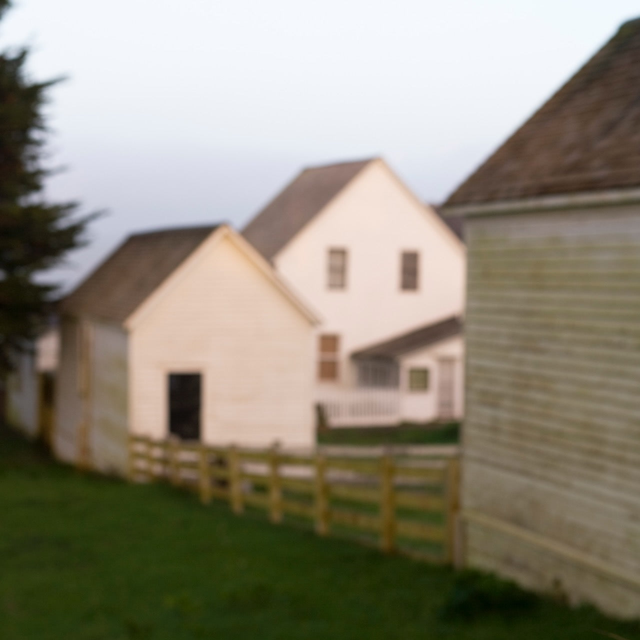 Intentionally blurred image of whitewashed barns and buildings at Pierce Point Ranch, with soft shapes and muted tones evoking a dreamlike memory of the past; winner of first place at the Marin County Fair photo competition.