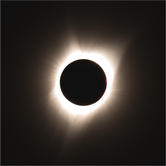 A total solar eclipse captured in 2017 in eastern Oregon, showing the darkened moon perfectly centered with the sun’s glowing corona radiating outward.